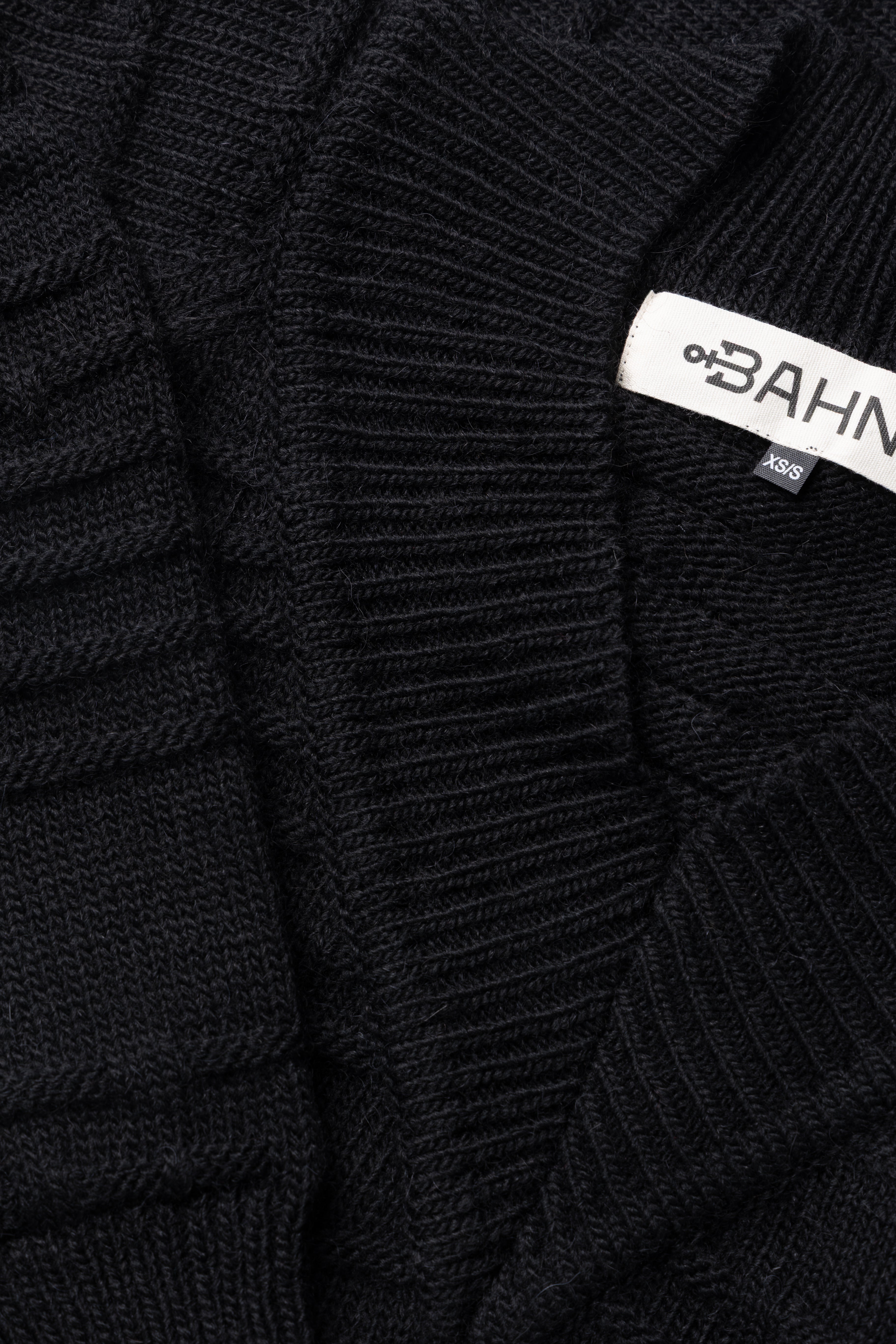 closeup of knitting details for Claire BAHNS wool sweater in black