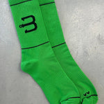 A pair of bright green sport socks with BAHNS logo