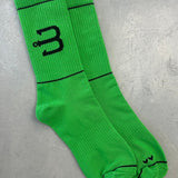 A pair of bright green sport socks with BAHNS logo