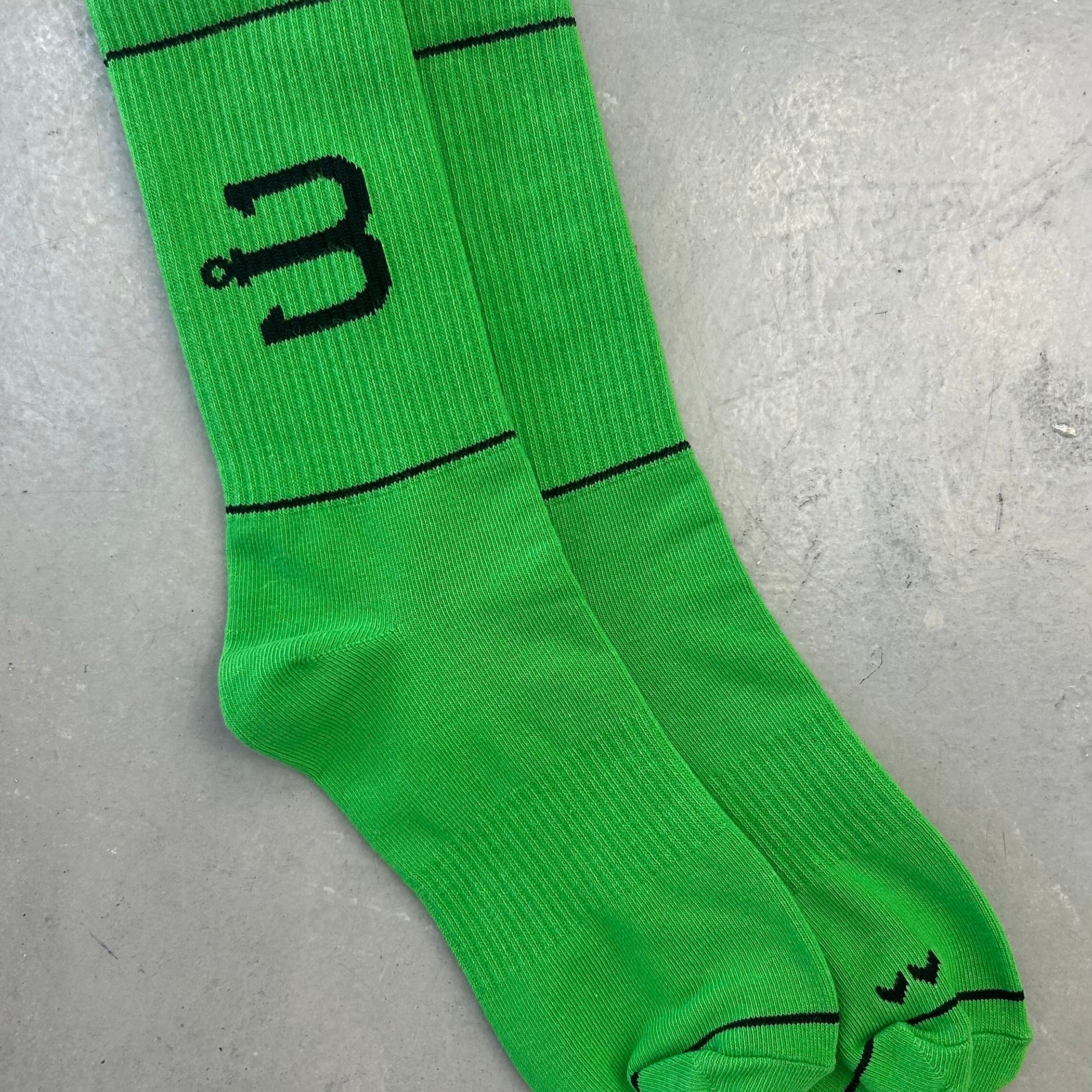 A pair of bright green sport socks with BAHNS logo