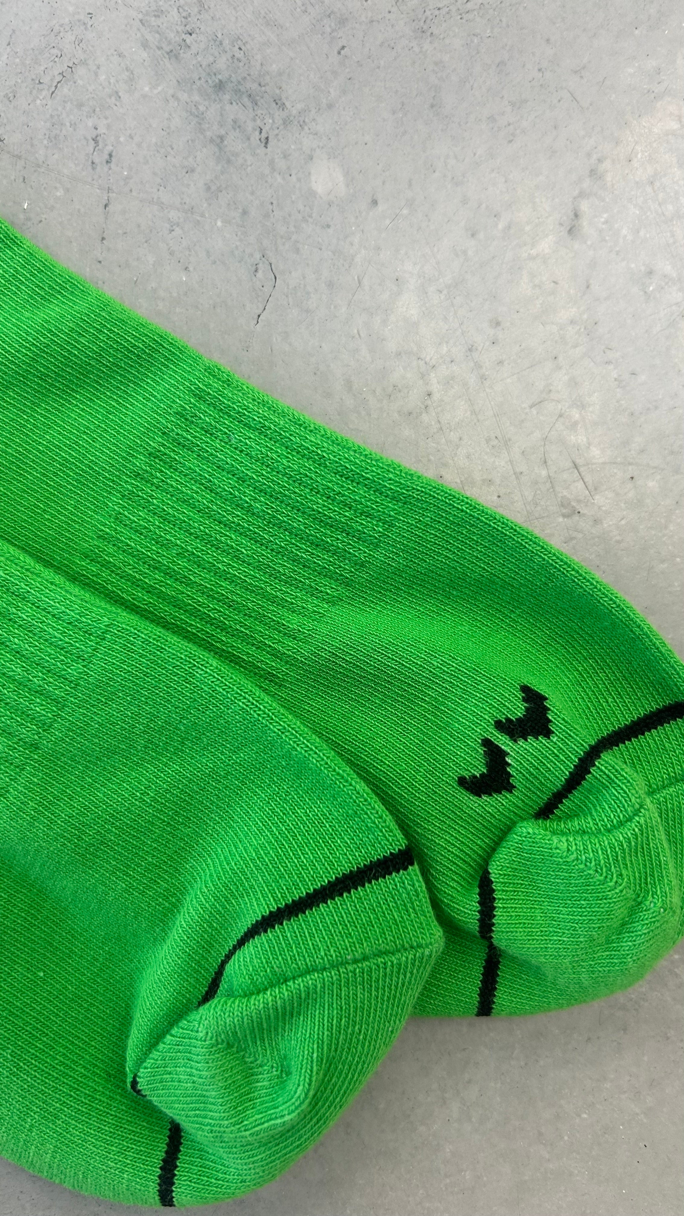 Bright green athletic socks with black graphics