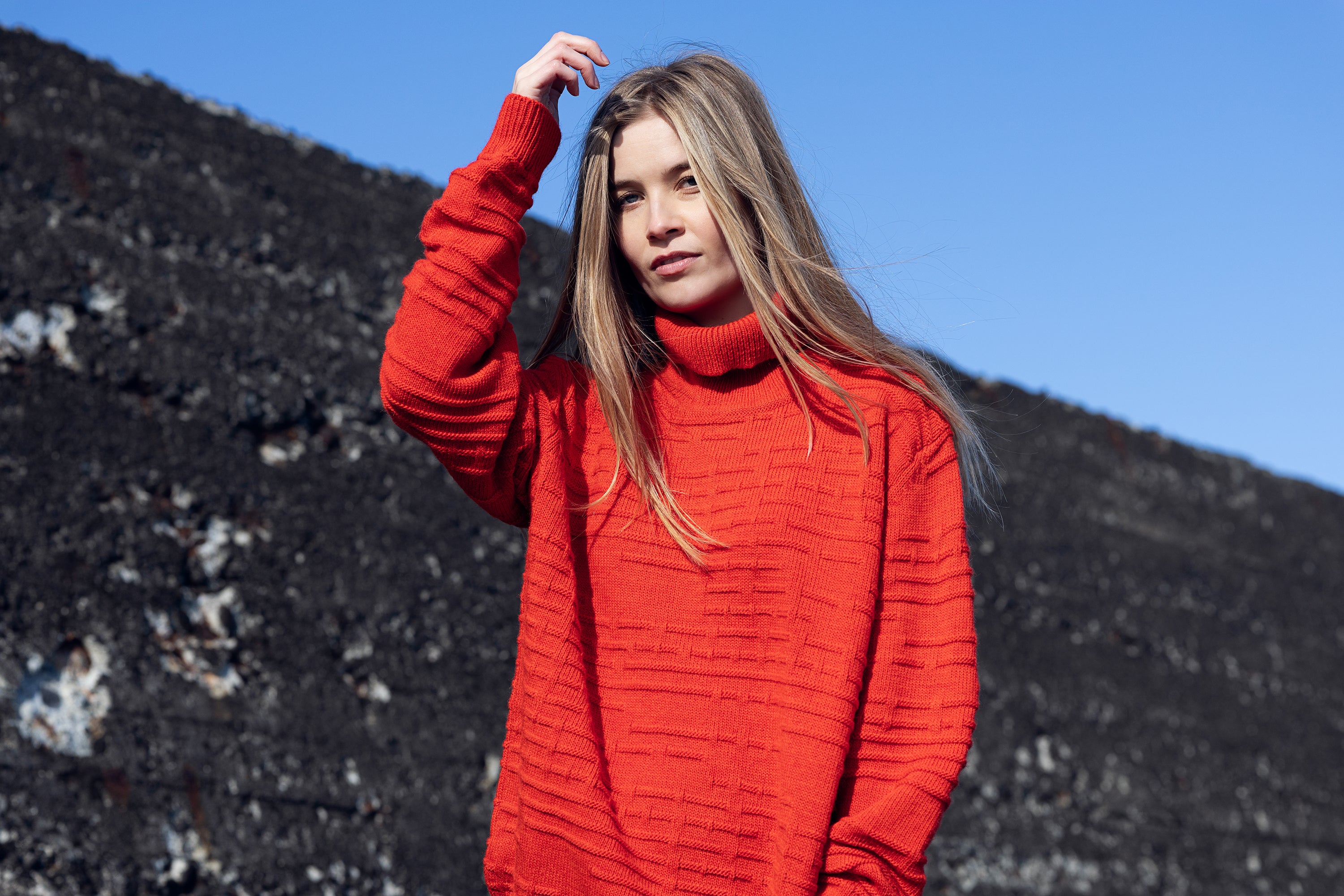 Soft wool sweater in orange with turtleneck worn by model